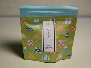 Green tea package with colorful triangle patterns on a white background