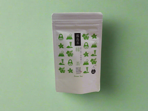 Tea packaging with green graphics on a white background